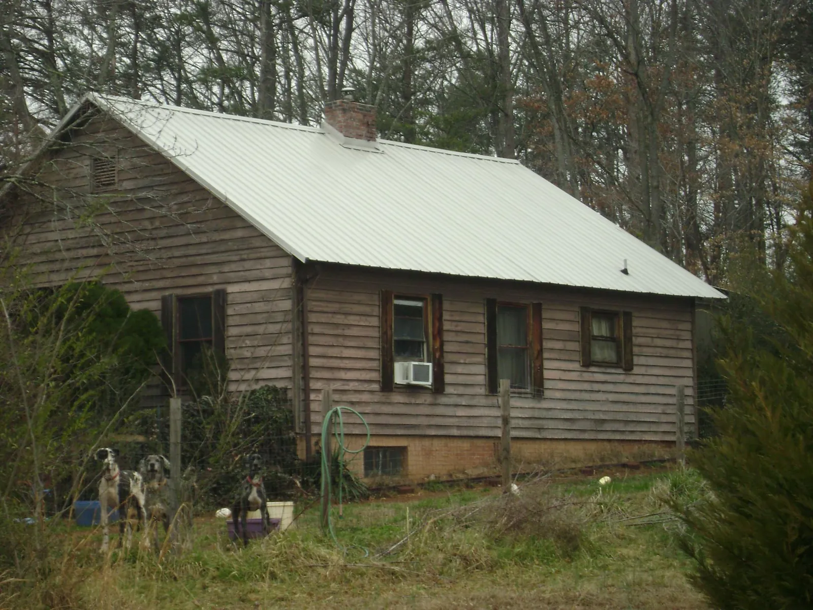 White metal roof on an old wood sided farmhouse, from a Metal Roof Installation job in Wellsburg